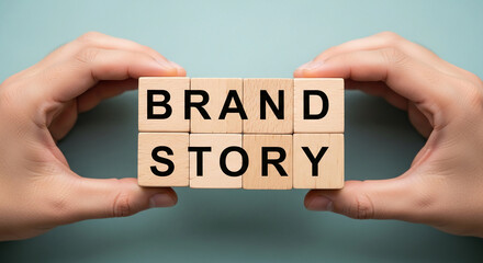 Hands hold wooden blocks spelling "Brand Story," showcasing the concept of brand building and narrative marketing