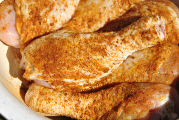 raw chicken legs with spices ready for cooking
