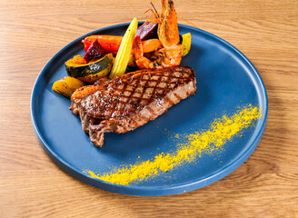 Sirloin Steak and King Prawns with Red Wine Sauce in plate top view of Hong Kong food