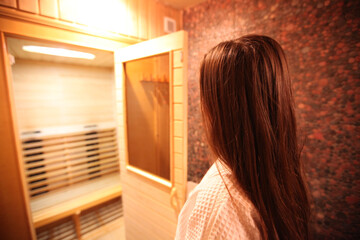 Woman contemplating a sauna experience