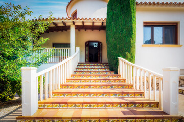 Stairs at the entrance to the villa. Stairs, house, and garden elements in Mediterranean style.