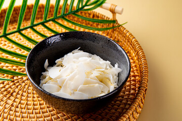 Coconut chips in a bowl. Cocos nucifera.