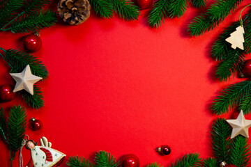 Elegant top view Christmas decorations arranged on a vibrant red background, frame conveying warmth and holiday cheer, copy space for text