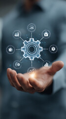 Hand holding a digital gear network with icons for data, analytics, and business growth technology