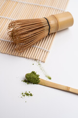 Green matcha close-up. Chasen, bamboo whisk. Traditional tools for making matcha. Matcha powder. Making matcha, recipe.