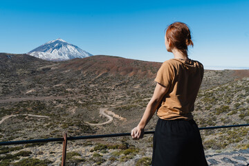 Woman enjoying the view of Teide volcano, El Teide National Park, Tenerife, Canary Islands, Spain.