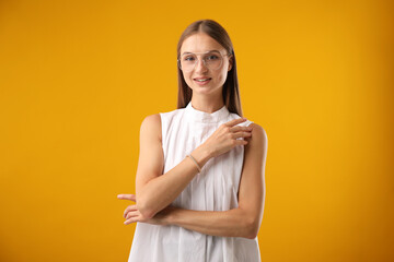 Obraz premium Portrait of beautiful woman on yellow background