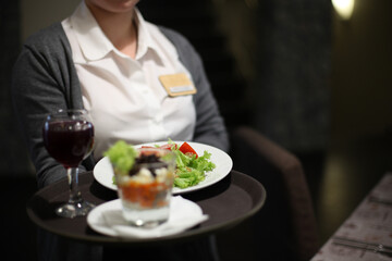 Waitress serving food and wine at a restaurant