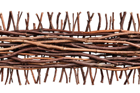 A rustic woven fence made from natural brown branches and twigs.