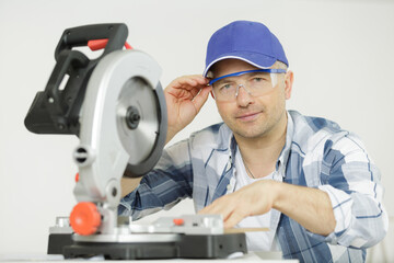 carpenter middle-aged man working with a circular saw