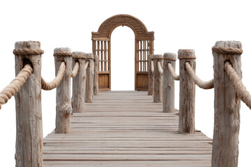 Old wooden pier with rope handrails leading to an arched gate.