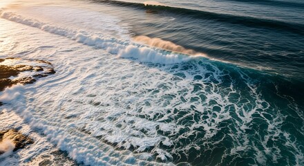 Ocean waves texture captured from above with foamy white crests creating abstract natural patterns