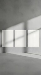 Fototapeta premium Blank square canvases on a textured concrete wall with dramatic light and shadow creating a gallery-like exhibition space, perfect for art display and mockup presentations