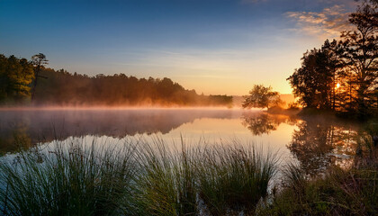 a serene lake scene at dawn with a mist rising
