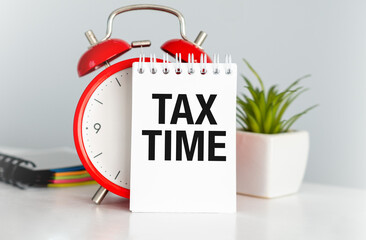 Time: Alarm clock, income tax time note. Woman background. Reminder.