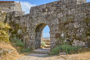 Fototapeta premium Ancient stone archway entrance with historic architecture in Monsanto, Portugal.