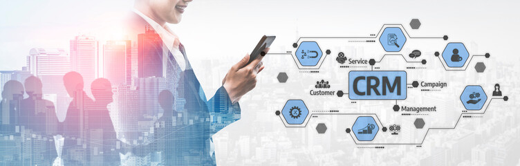 A business professional interacts with a mobile device, surrounded by CRM elements and an urban skyline, showcasing the integration of technology in modern management strategies. Tessel