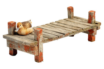 Miniature rustic wooden pier with a small duck figurine.