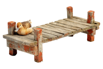 Miniature rustic wooden pier with a small duck figurine.