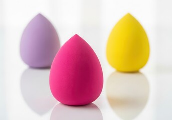Obraz premium Three colorful makeup sponges isolated on white background