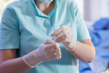 Nurse in gloves preparing syringe for vaccination in clinic closeup © st.kolesnikov
