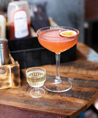 Pornstar Martini cocktail on a bar counter with beautiful bokeh in the background