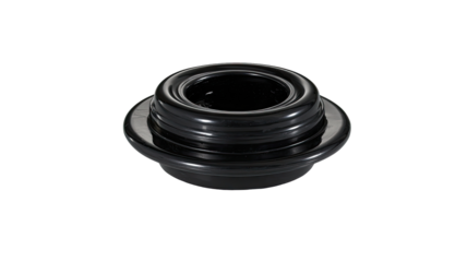 Close-up of a dark, circular, black plastic part.  Rings and grooves visible