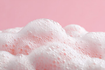 Fototapeta premium Close-up of pink frothy bubbles against a pastel background