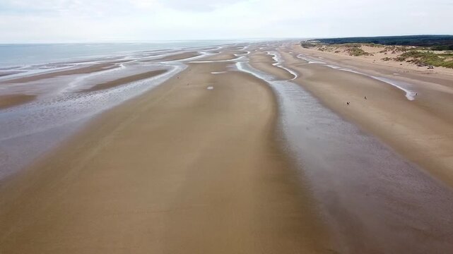 Scenery flight over Formby beach at low tide near Liverpool, England