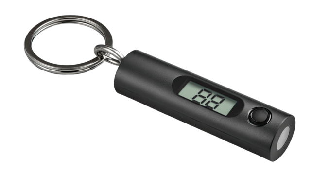 A small, black, cylindrical keychain-mounted digital gauge.  Features a digital display showing a numerical value, likely a measurement, and a metal keyring