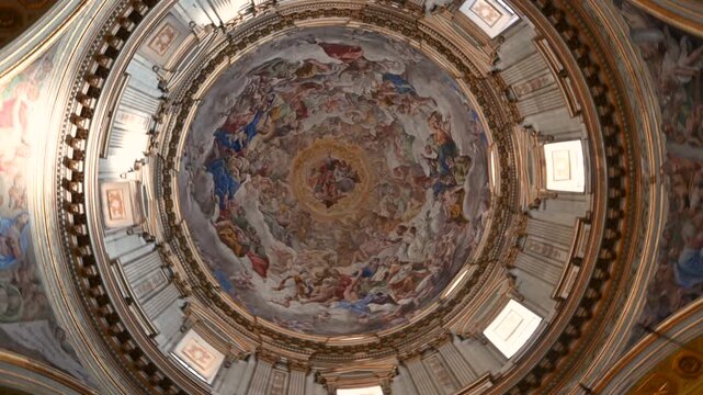 Naples, Italy, December 27, 2024. Fascinating rotating footage inside the Cathedral of Santa Maria Assunta. The movement explores the magnificent, finely decorated dome ceiling. Travel destinations.