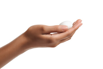 A hand holds a single, white egg.  Close-up, soft lighting, simple composition