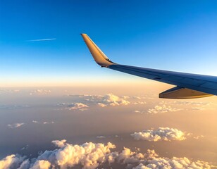 Airplane wing over clouds at sunset