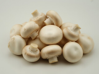 Large Pile of Fresh White Button Mushrooms, Raw Whole Agaricus Bisporus Fungi for Cooking,  Healthy Culinary Vegetable Ingredient on a Plain Background