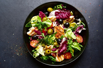 Green salad with grilled chicken fillet. Top view with copy space.