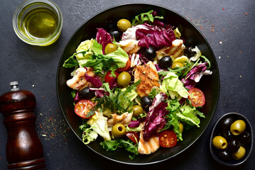 Green salad with grilled chicken fillet. Top view with copy space.