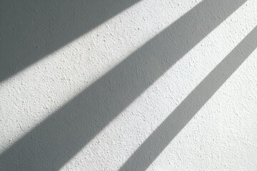 Fototapeta premium Sunlight casts parallel shadows on textured wall