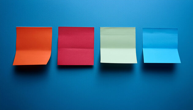 Colorful Sticky Notes Arranged In A Gradient From Red To Blue On A Blue Wall With Some Notes Partially Folded At The Top