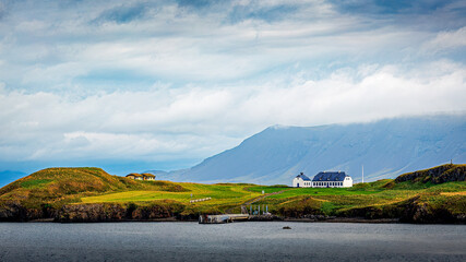 Building on green peninsula in Iceland near Reykjavik
