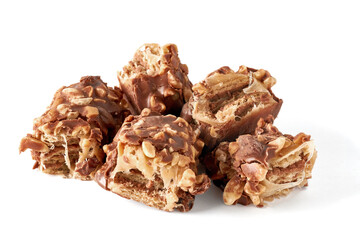 pieces broken chocolate caramel wafer bar with nuts isolated on white background