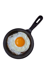 fried egg in black cast iron frying pan isolated on white background.