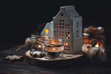 Creative handmade christmas home decor decorations: simple glass jars with aroma candles decorated with a ribbon, cinnamon, anise, dry orange. Cozy atmospheric composition for holiday mood creation