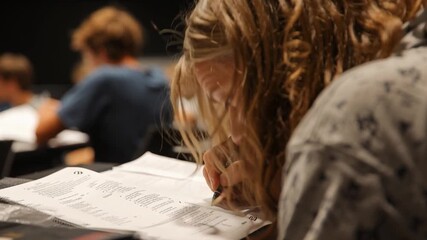 Adult student taking notes in night class