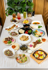 Traditional Middle Eastern dishes served on a white table in restaurant interior