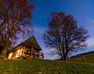 Fototapeta premium Rustic cabin bathed in moonlight, under a starry night sky
