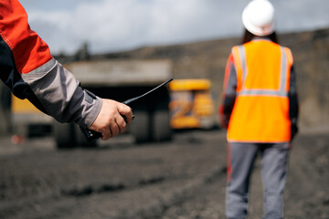 Workers on duty at open pit coal mine using communication devices