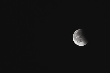 Close-up of the moon during a lunar eclipse against a dark night sky.