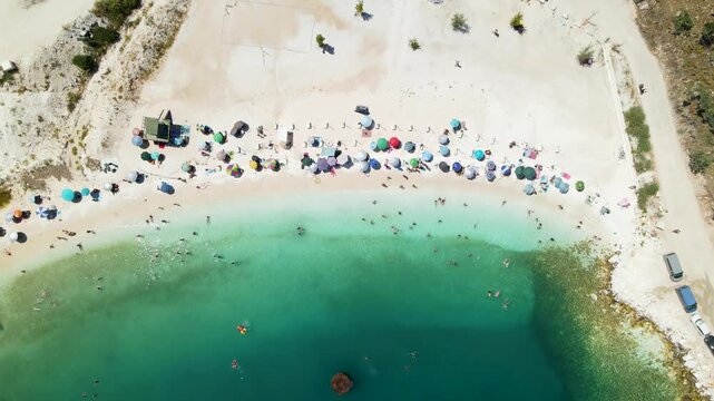 Porto Vathy beach, sand and umbrellas on beach, Thassos Island, Greece. One of the most beautiful beaches in Greece. Amazing beach with clear blue water. Aerial panoramic drone view from above, top vi