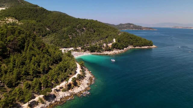 Porto Vathy beach, sand and umbrellas on beach, Thassos Island, Greece. One of the most beautiful beaches in Greece. Amazing beach with clear blue water. Aerial panoramic drone view from above, top vi
