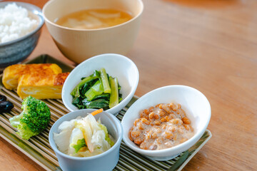 Traditional Japanese breakfast with rice, miso soup, natto and side dishes